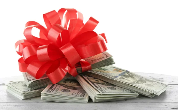 Pile of dollars with bow — Stock Photo, Image