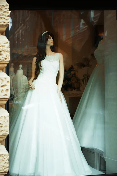 White wedding dress on mannequin in a showcase