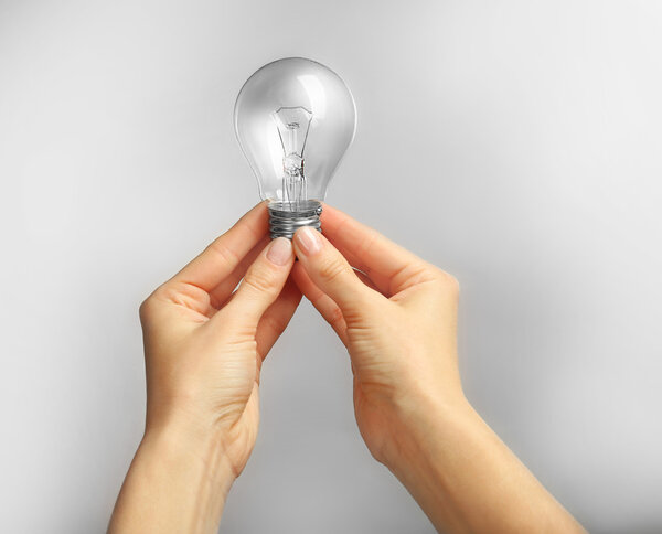 Woman hands holding bulb 