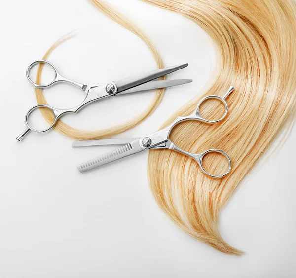 Hairdresser's scissors with strand of hair — Stock Photo, Image