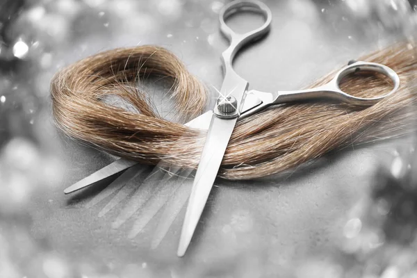 Hairdresser's scissors with strand of hair — Stock Photo, Image
