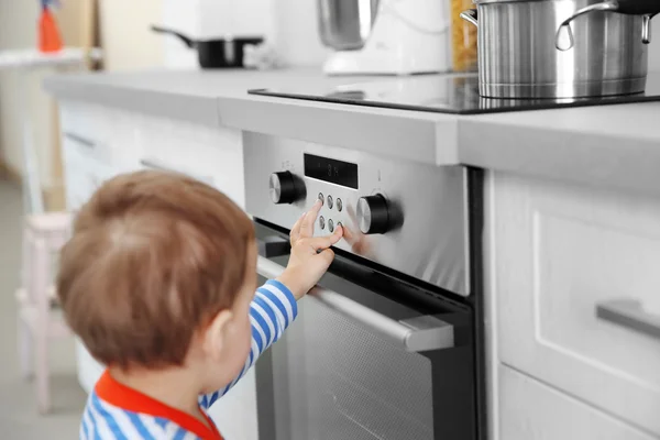 Child playing with electric stove