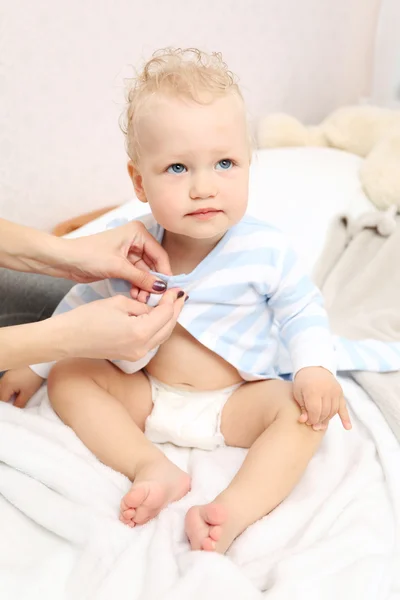 Mother dressing baby — Stock Photo, Image