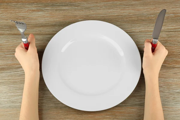 Woman holding fork and knife