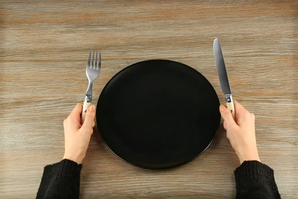 Woman holding fork and knife