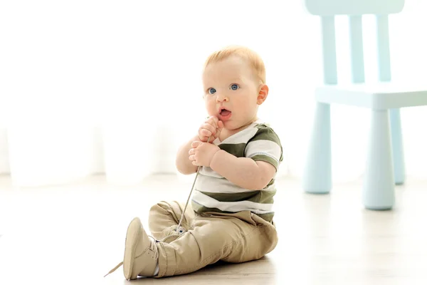 Baby sitting on floor — Stock Photo, Image