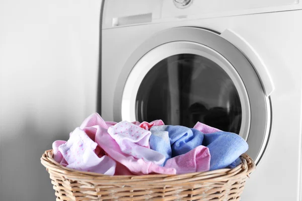 Baby clothes and washing machine — Stock Photo, Image