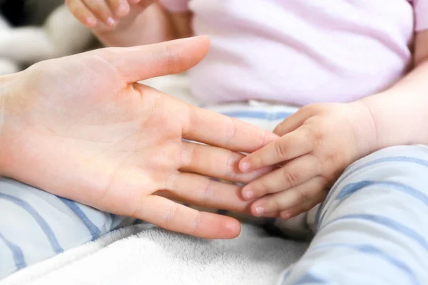 Woman holding baby hand — Stock Photo, Image