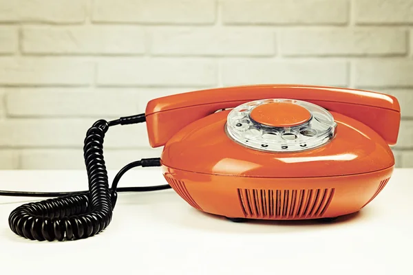 Retro telephone on wall background — Stock Photo, Image