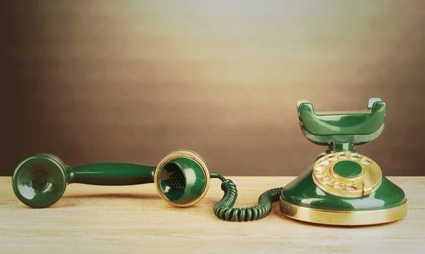 Retro phone on wooden table — Stock Photo, Image