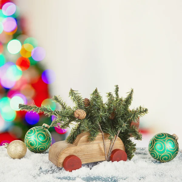 Toy car carrying Christmas tree — Stock Photo, Image