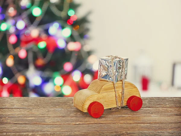 Wooden toy car carrying gift — Stock Photo, Image
