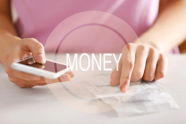 Woman with bills and smart phone — Stock Photo, Image