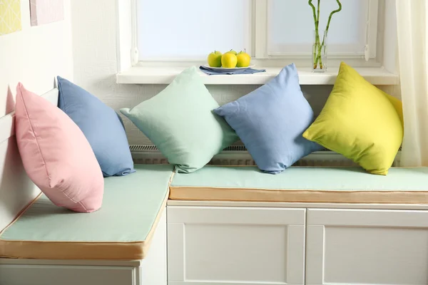 Colorful pillows on nook furniture — Stock Photo, Image