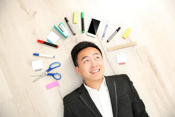 Handsome businessman with office supplies — Stock Photo, Image