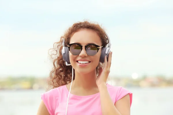 Femme écoutant de la musique dans les écouteurs — Photo