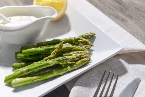 Asparagus with lemon and sauce Stock Picture