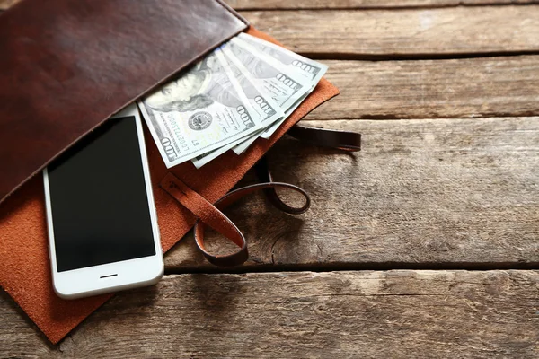 Leather purse with mobile phone — Stock Photo, Image