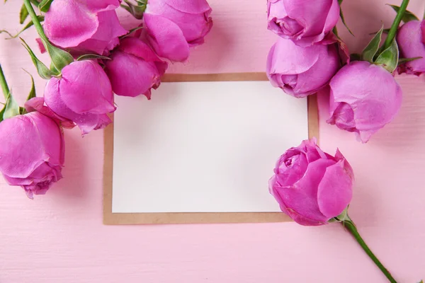 Fresh roses and photo frame — Stock Photo, Image