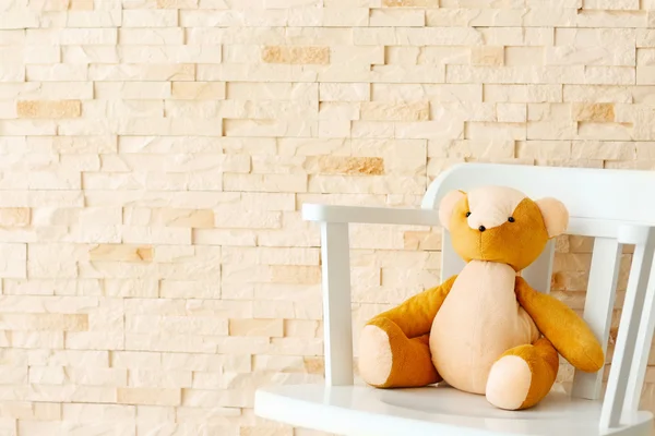 Baby toy on brick wall — Stock Photo, Image