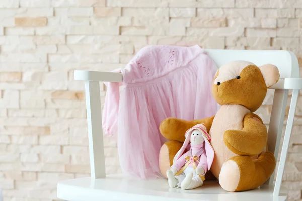 Baby toy and pink dress — Stock Photo, Image