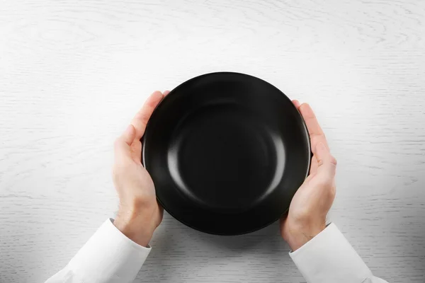 Man holding empty plate. — Stock Photo, Image