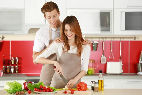 Couple in aprons cooking — Stock Photo, Image