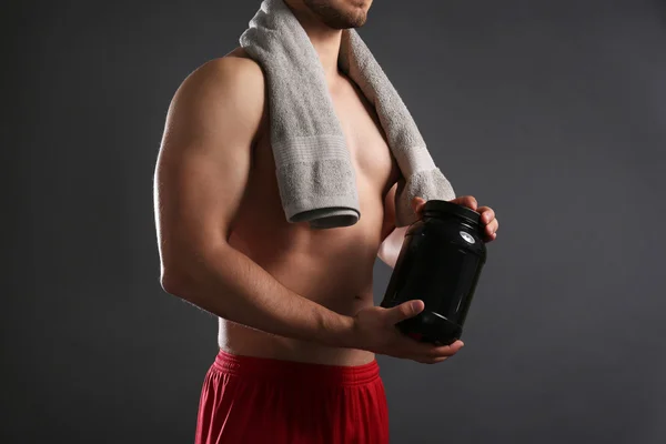 Young man with sports nutrition — Stock Photo, Image