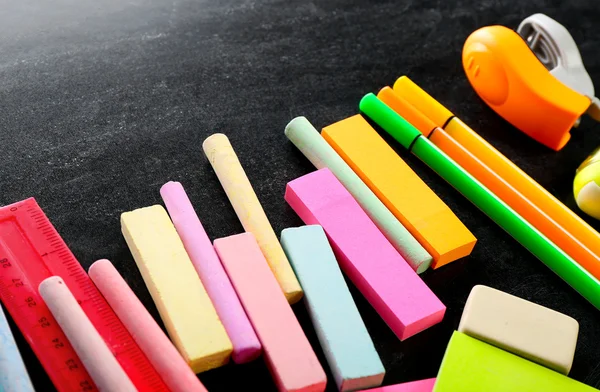 Colourful stationery on black — Stock Photo, Image