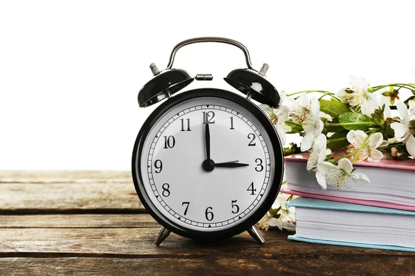 Alarm clock and spring blooming branches — Stock Photo, Image