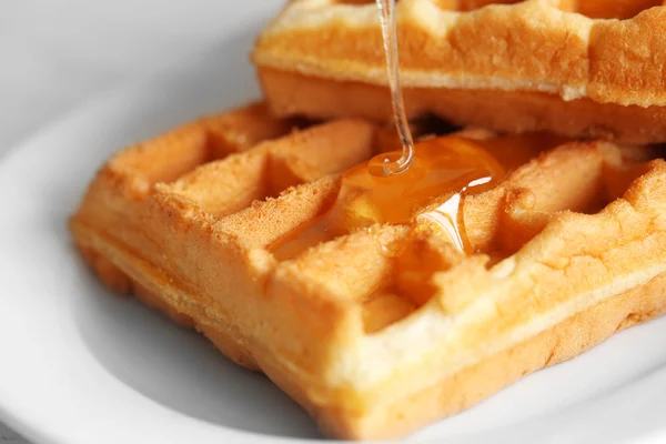 Tasty waffles with honey — Stock Photo, Image