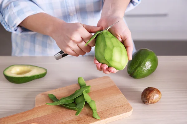 Mujer cortando aguacate fresco — Foto de Stock