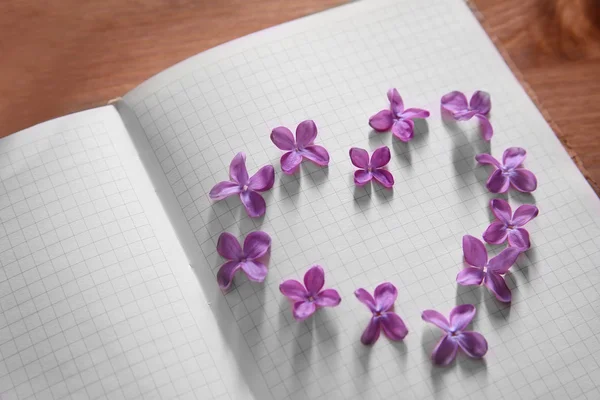 Lilac flowers in a heart shape — Stock Photo, Image