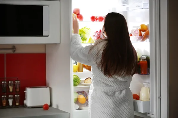 Young woman and fridge — Stock Photo, Image