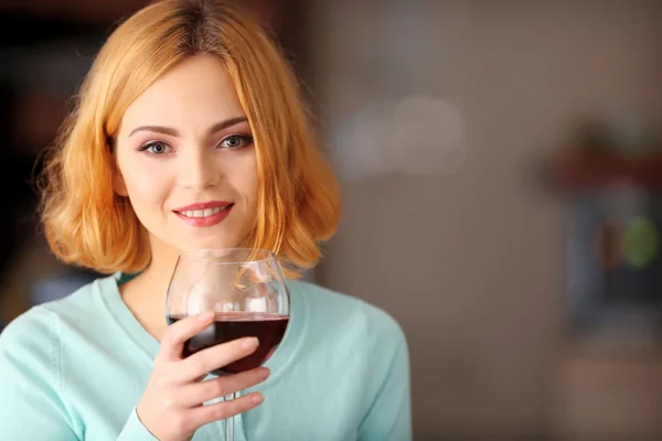 Woman with glass of red wine Stock Image