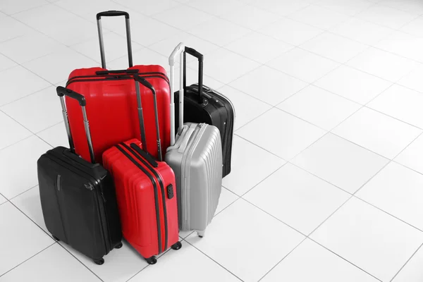 Different suitcases standing on floor — Stock Photo, Image