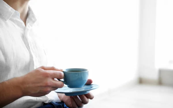 Mavi fincan kahve tutan adam — Stok fotoğraf