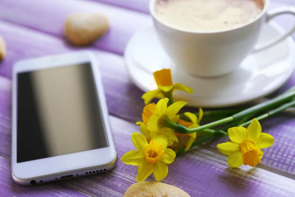 Kopje koffie met gele narcissen — Stockfoto