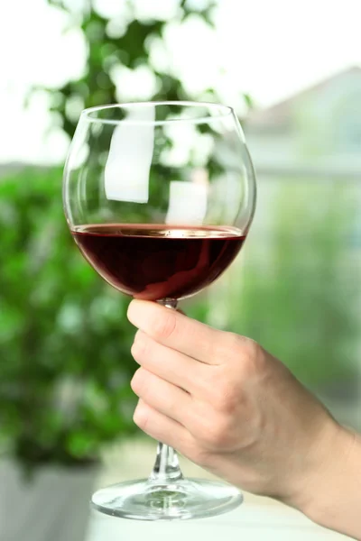 Woman holding glass of wine — Stock Photo, Image