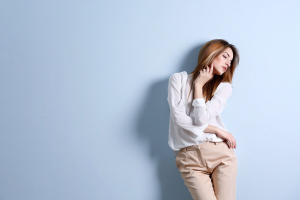 woman in a white shirt and beige pants