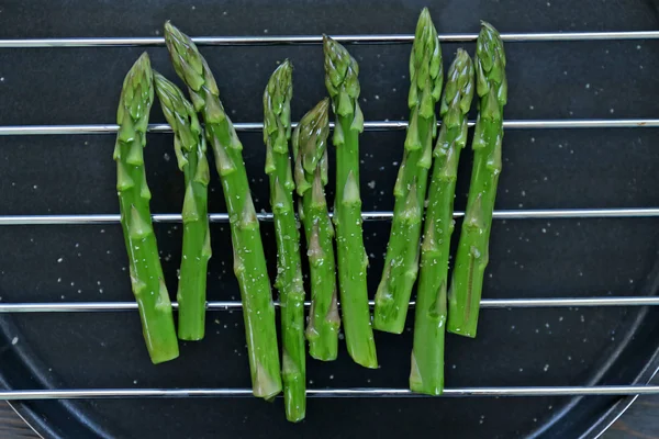 Asparagus on grill on background — Stock Photo, Image