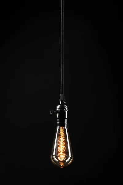 Light bulb on black background — Stock Photo, Image