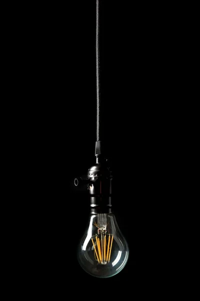 Light bulb on black background — Stock Photo, Image