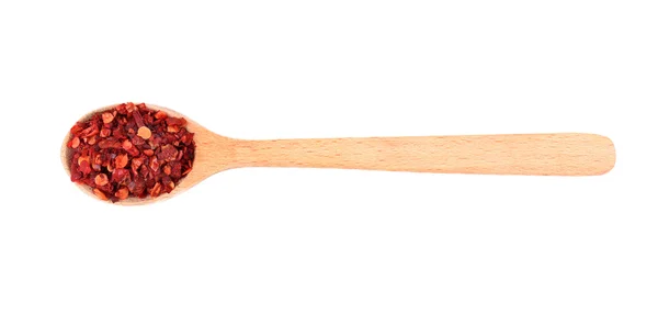 Dried chopped chili pepper in spoon — Stock Photo, Image