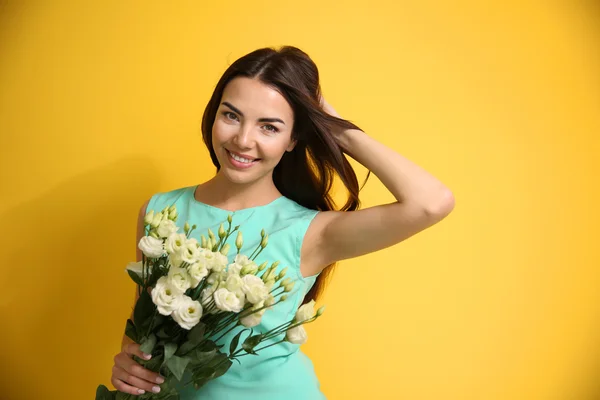 Schöne junge Frau mit Blumenstrauß — Stockfoto