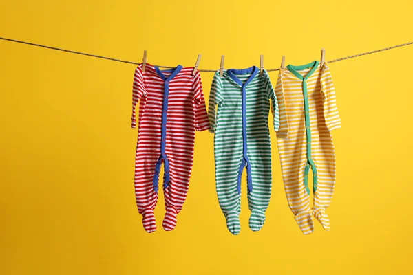 Baby clothes hanging on rope — Stock Photo, Image