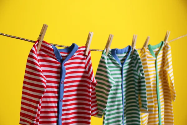 Baby clothes hanging on rope — Stock Photo, Image