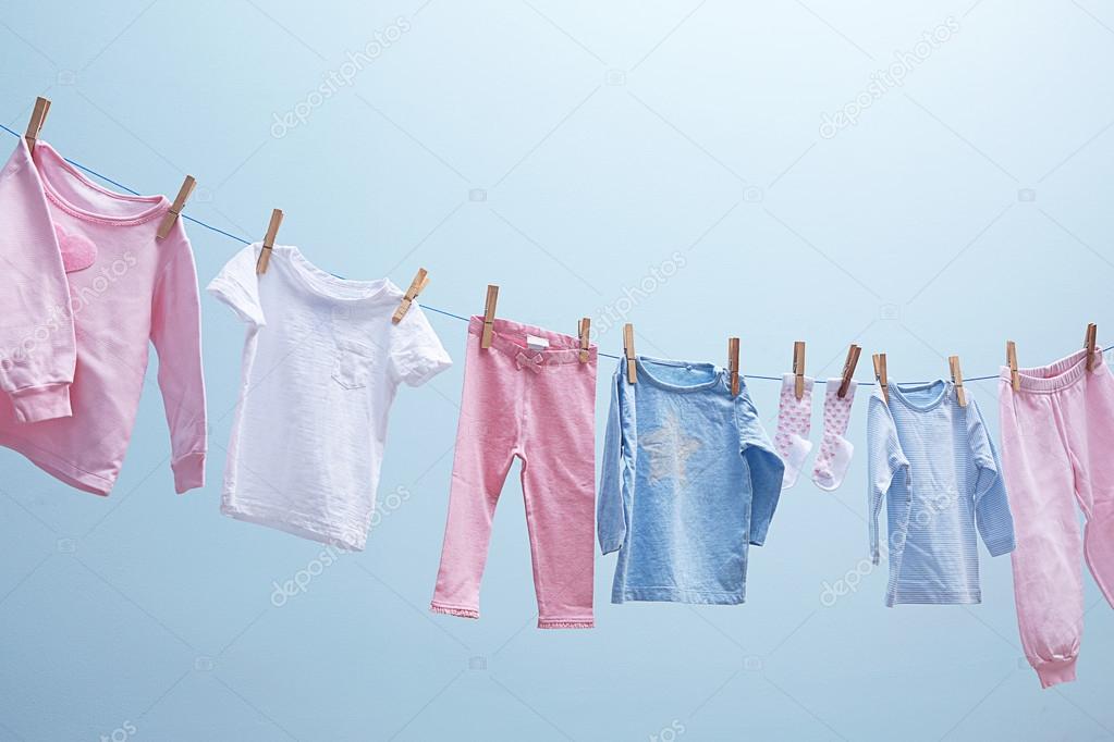 Baby clothes hanging on rope — Stock Photo © belchonock #114371012