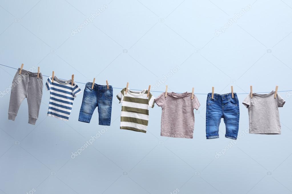 Baby clothes hanging on rope Stock Photo by ©belchonock 114371024