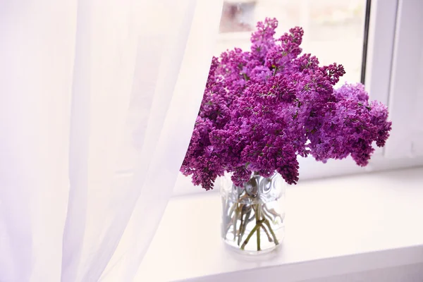 Lilac bouquets in glass jar — Stock Photo, Image